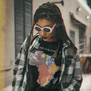 The TRUE SIZE of Africa - t shirt mockup of a woman wearing a grunge inspired outfit m e - Shujaa Designs